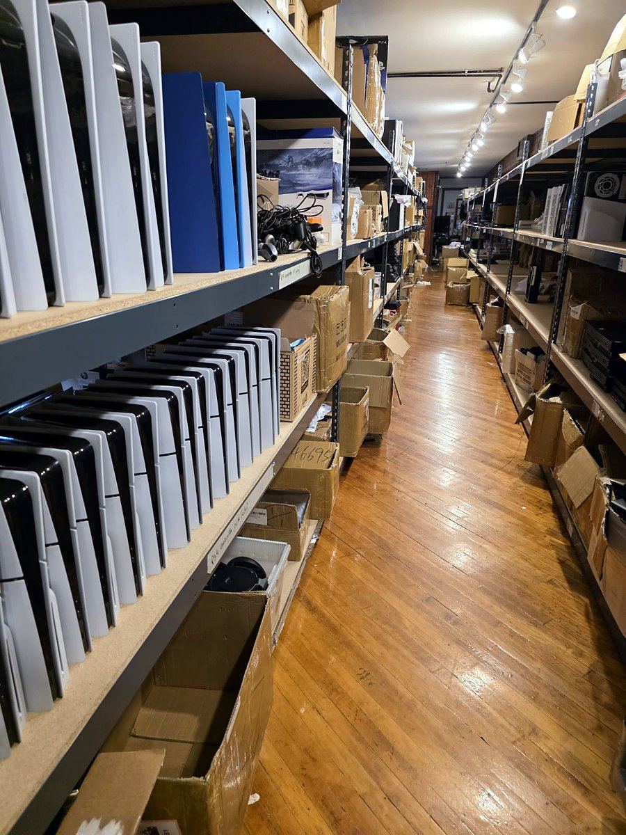 Shelves of consoles lining an aisle in the Retro vGames warehouse in Fleetwood, Pennsylvania