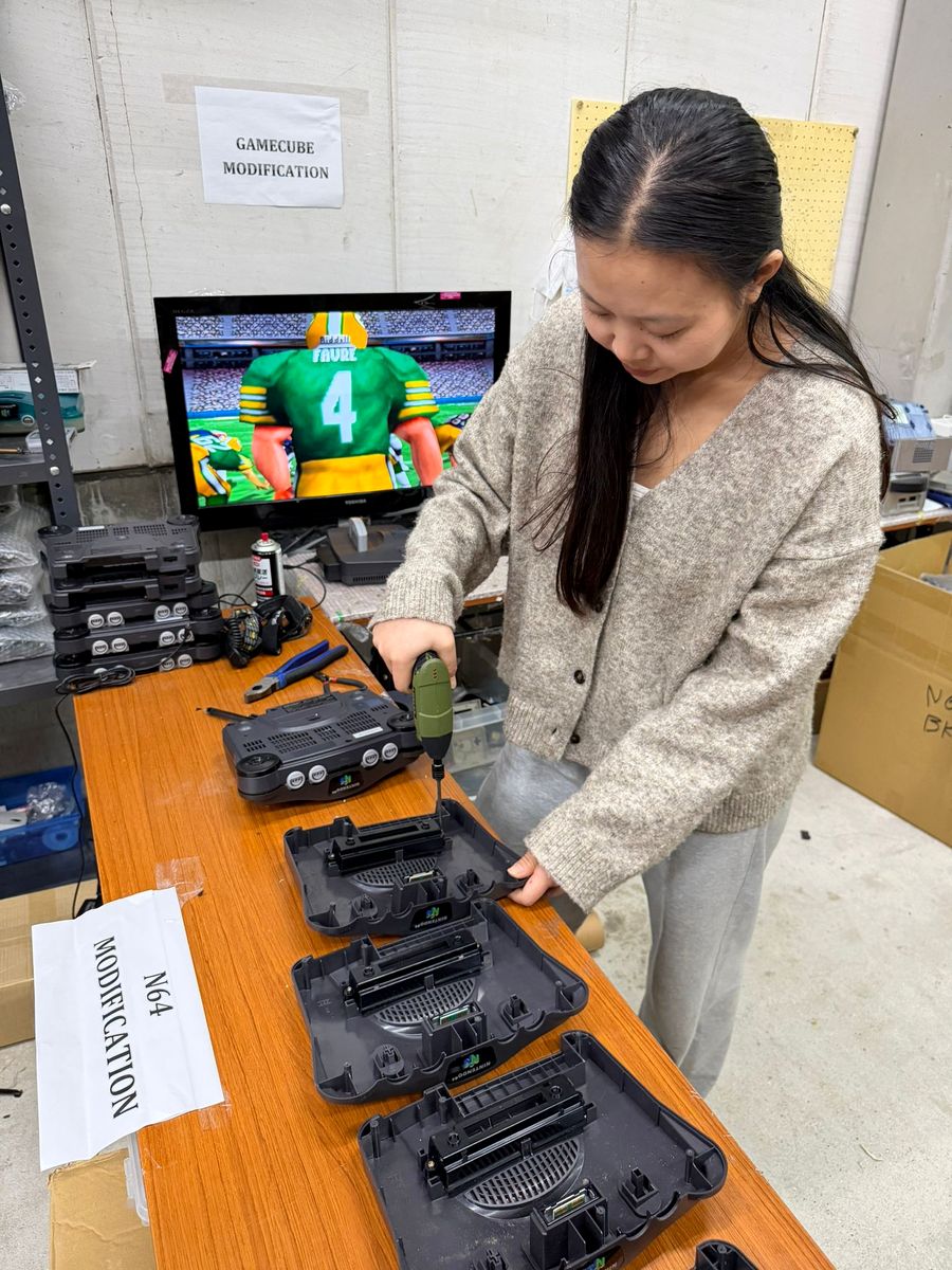A technician modifying Nintendo 64 consoles at the Retro vGames warehouse in Japan